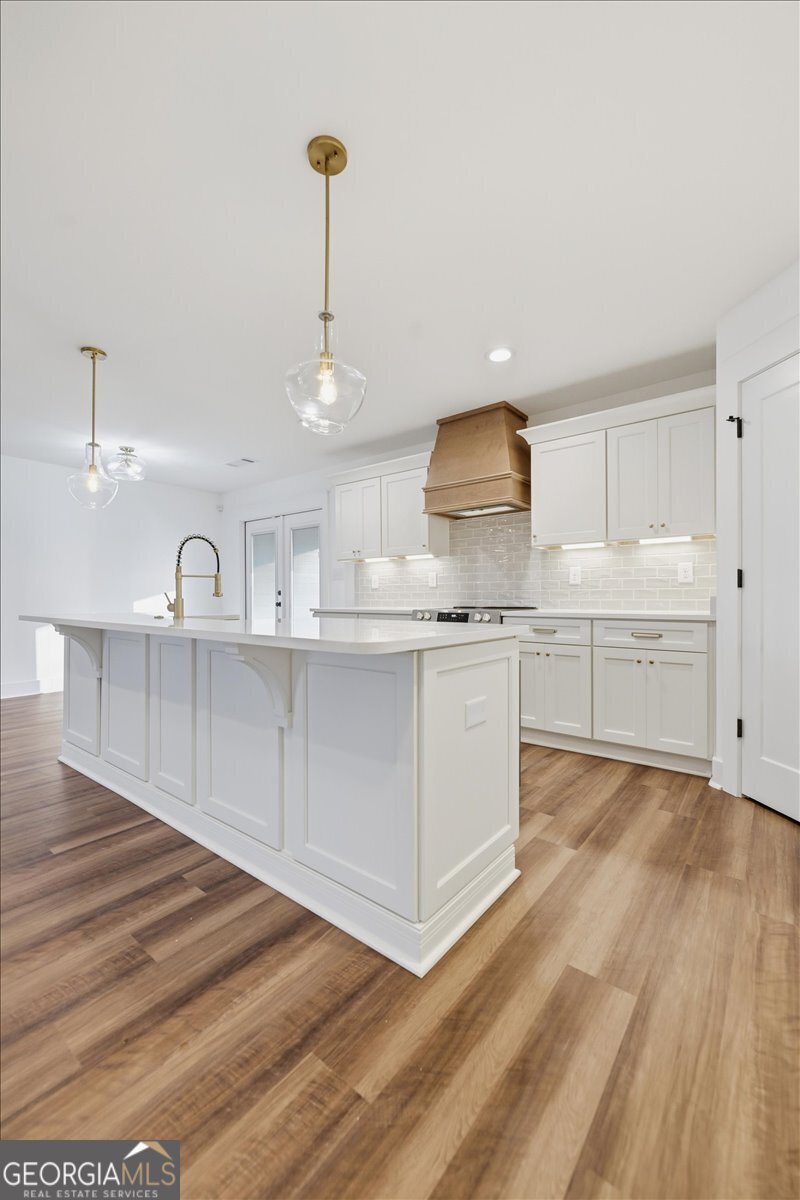 514 New Hope Drive Perry, GA 31069 - Photo 21 of 37 a kitchen with stainless steel appliances granite countertop a sink a stove and a wooden floors