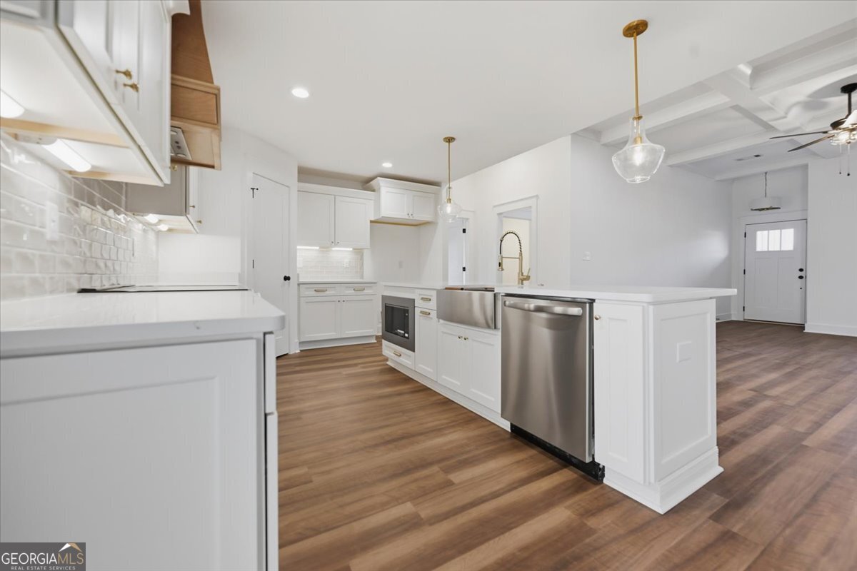 514 New Hope Drive Perry, GA 31069 - Photo 8 of 37 a large kitchen with white cabinets and wooden floor