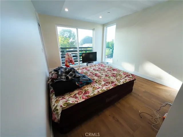 a bed sitting in a bedroom next to a window