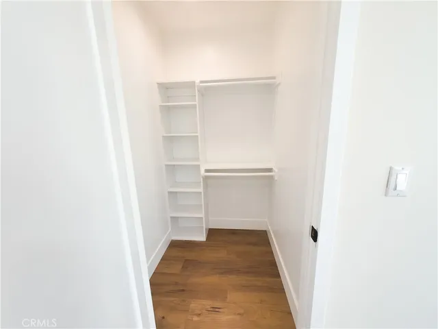 a view of walk in closet with empty racks