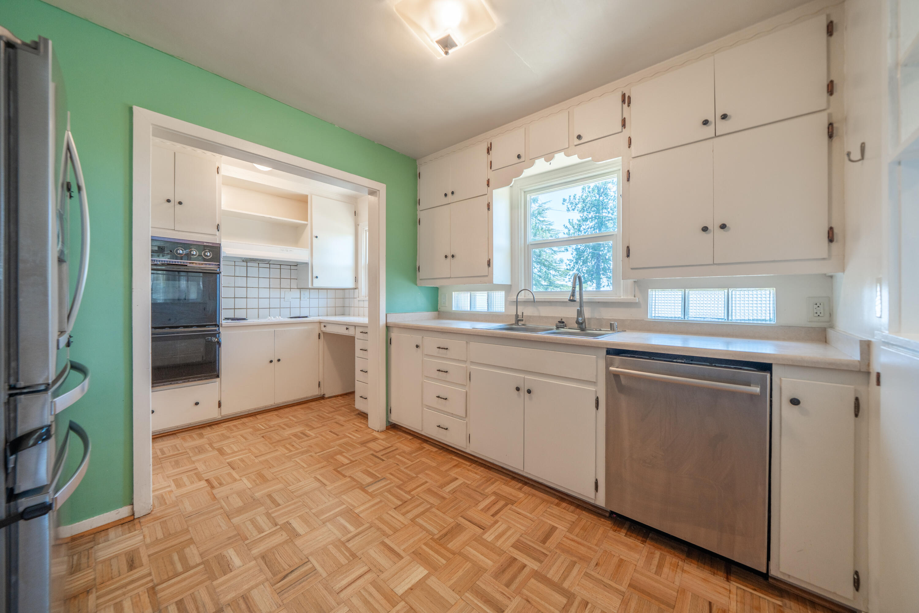 1550 Barbara Road Redding, CA 96003 - Photo 11 of 50 a kitchen with granite countertop a sink stainless steel appliances and cabinets