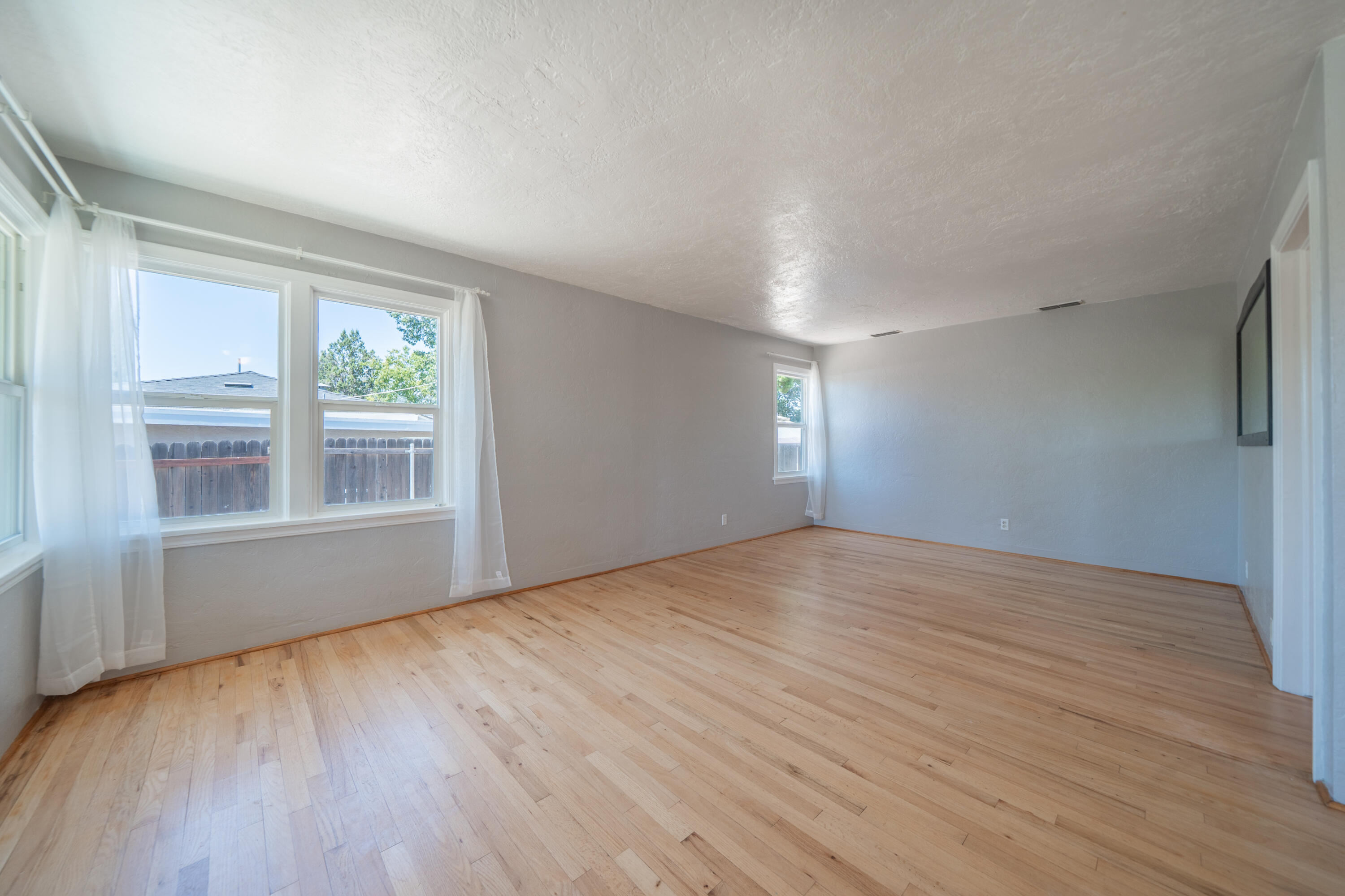1550 Barbara Road Redding, CA 96003 - Photo 8 of 50 a view of empty room with wooden floor and fan