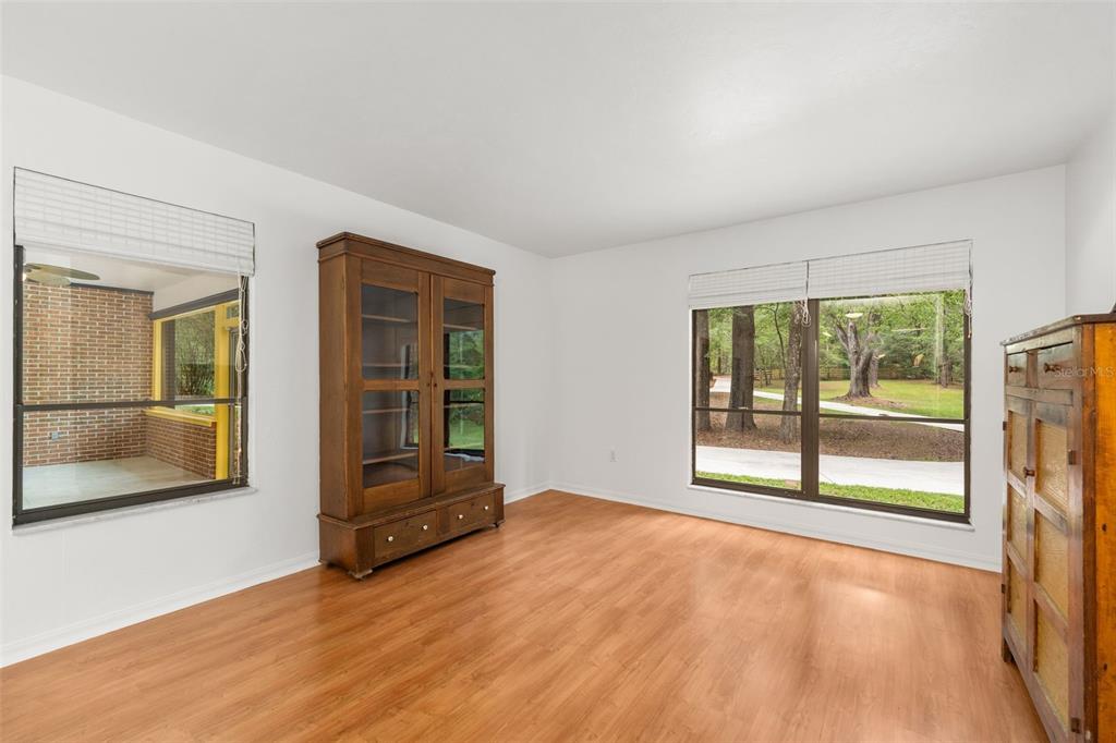 4703 Northwest 124th Street Gainesville, FL 32606 - Photo 15 of 55 an empty room with wooden floor and windows
