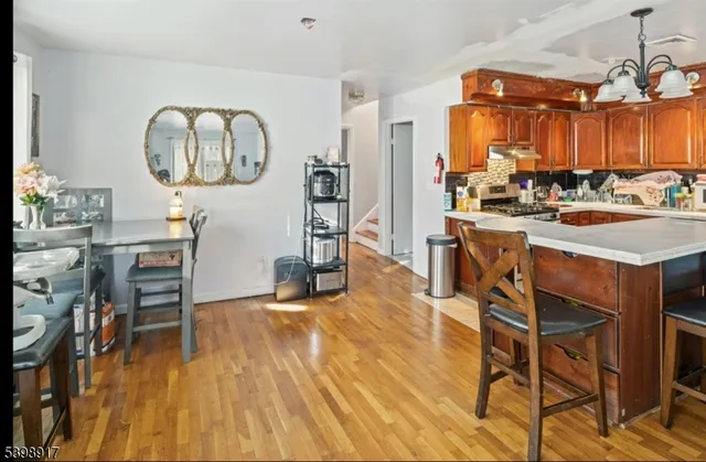 a view of a dining room with furniture and chandelier