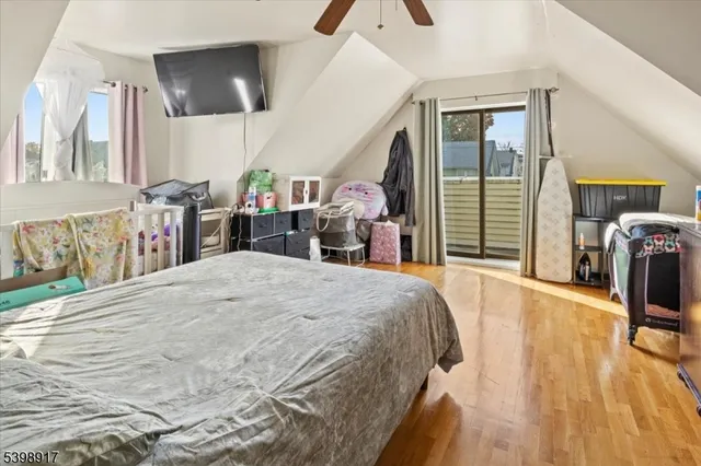 a bed room with a bed mirror and a chair