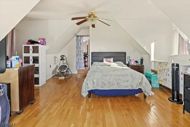 a spacious bedroom with a bed closet and a flat tv screen