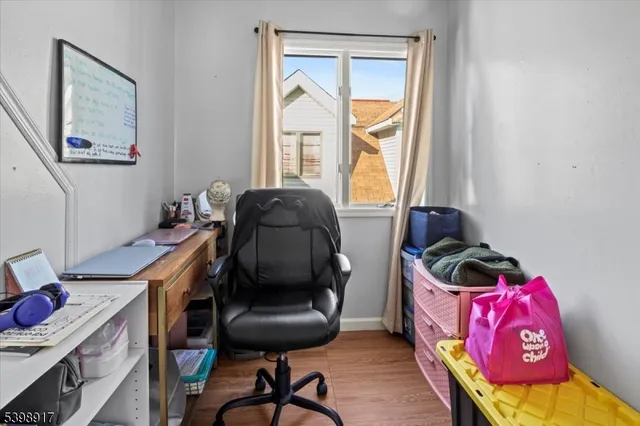 a view of a workspace with furniture and a window