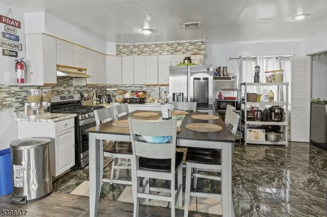 a kitchen with a table chairs stove and cabinets