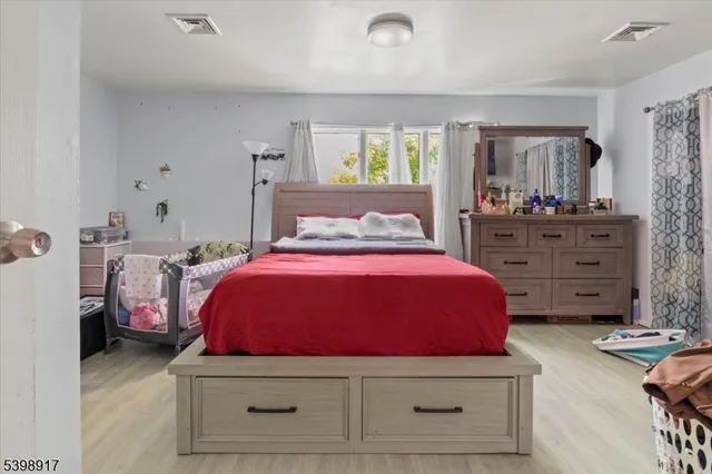 a bed room with a bed and a dresser