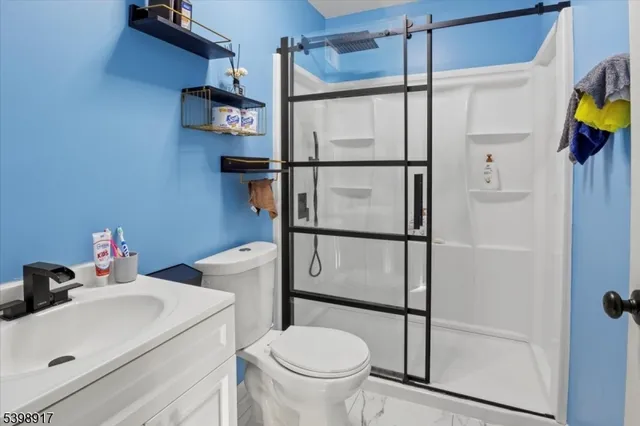 a bathroom with a toilet and a shower