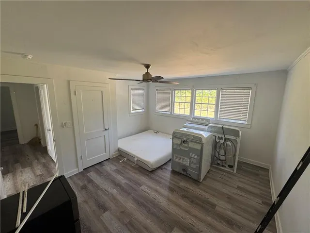 a bedroom with furniture and a window