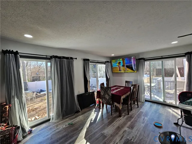 a view of a workspace with furniture and wooden floor