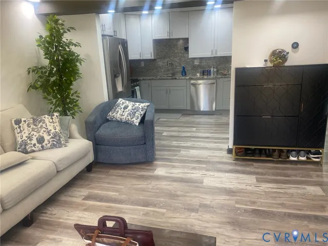 a living room with furniture and a potted plant