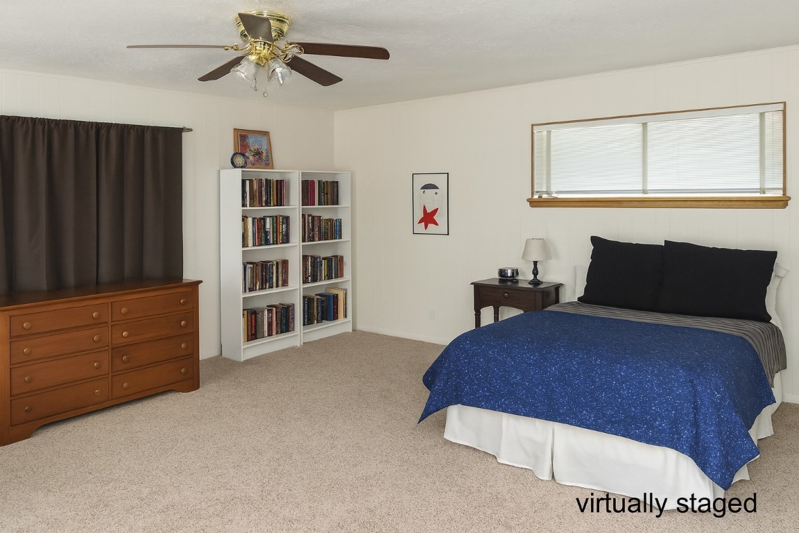 1205 Palo Duro Road Austin, TX 78757 - Photo 27 of 31 a bedroom with a bed and cabinet