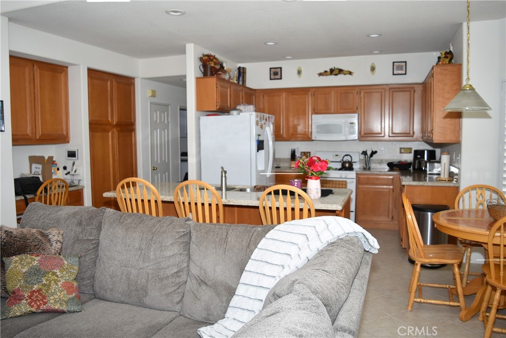 1665 Ravenswood Road Beaumont, CA 92223 - Photo 12 of 41 a living room filled with furniture and a chandelier