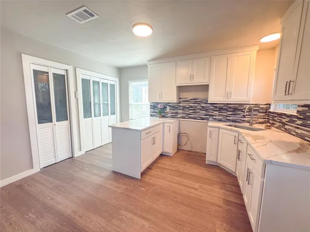 a kitchen with a sink stove and cabinets