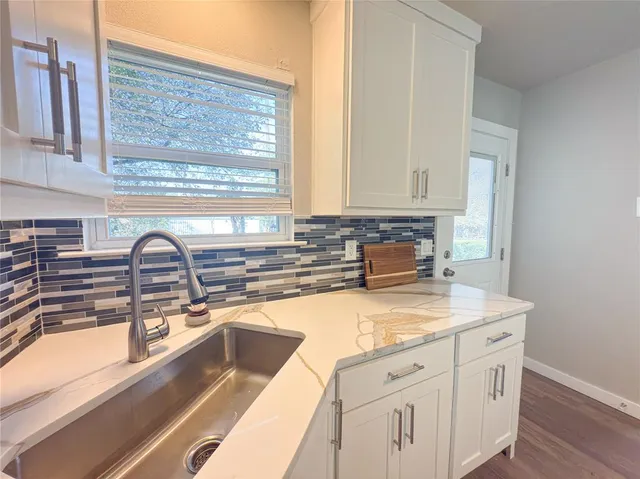 a bathroom with a sink and a large mirror