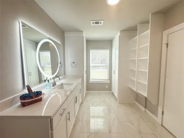 a bathroom with a double vanity sink and a mirror