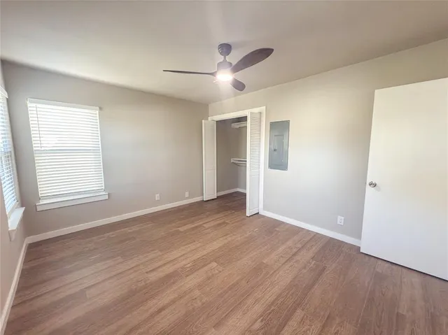 wooden floor in an empty room with a window