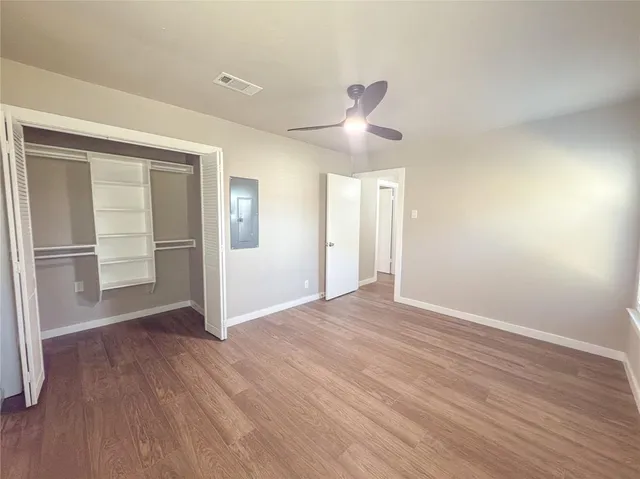 a view of walk in closet with wooden floor