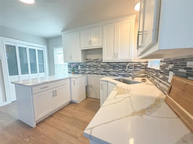 a bedroom with a bed and a potted plant