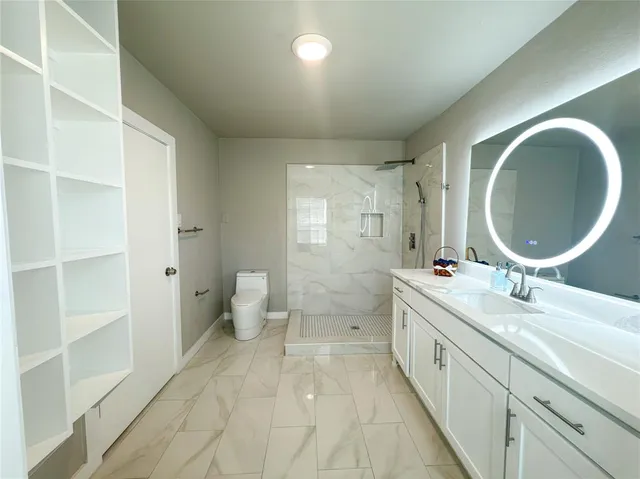 a bathroom with a double vanity sink a mirror and a