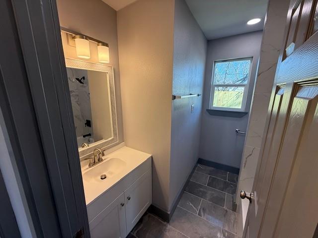 5845 Haney Drive Watauga, TX 76148 - Photo 17 of 37 a bathroom with a sink a mirror and a shower