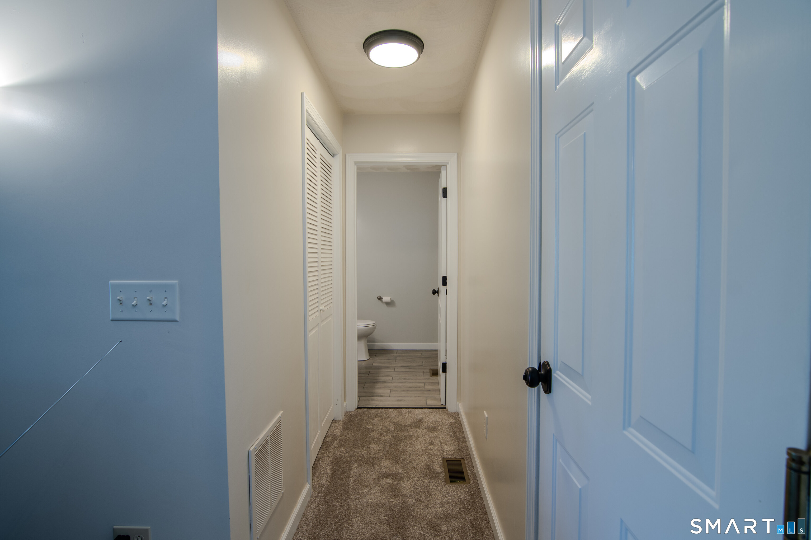297 Sabin Street, Unit 1 Putnam, CT 06260 - Photo 12 of 20 a view of a hallway with a livingroom and a bathroom with sink