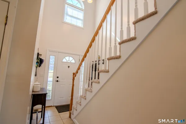 a view of entryway with wooden floor and stairs