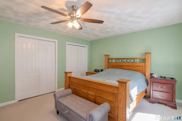 a bedroom with a bed and a chandelier