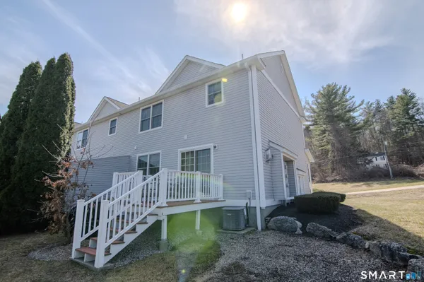 a view of a house with backyard and sitting area