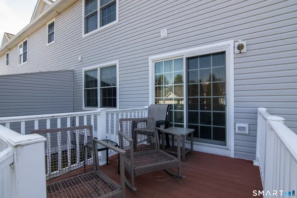 a view of a deck with table and chairs and wooden floor
