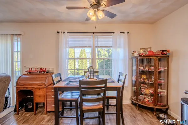 a view of a dining room with furniture and wooden floor
