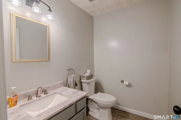 a bathroom with a sink toilet and vanity