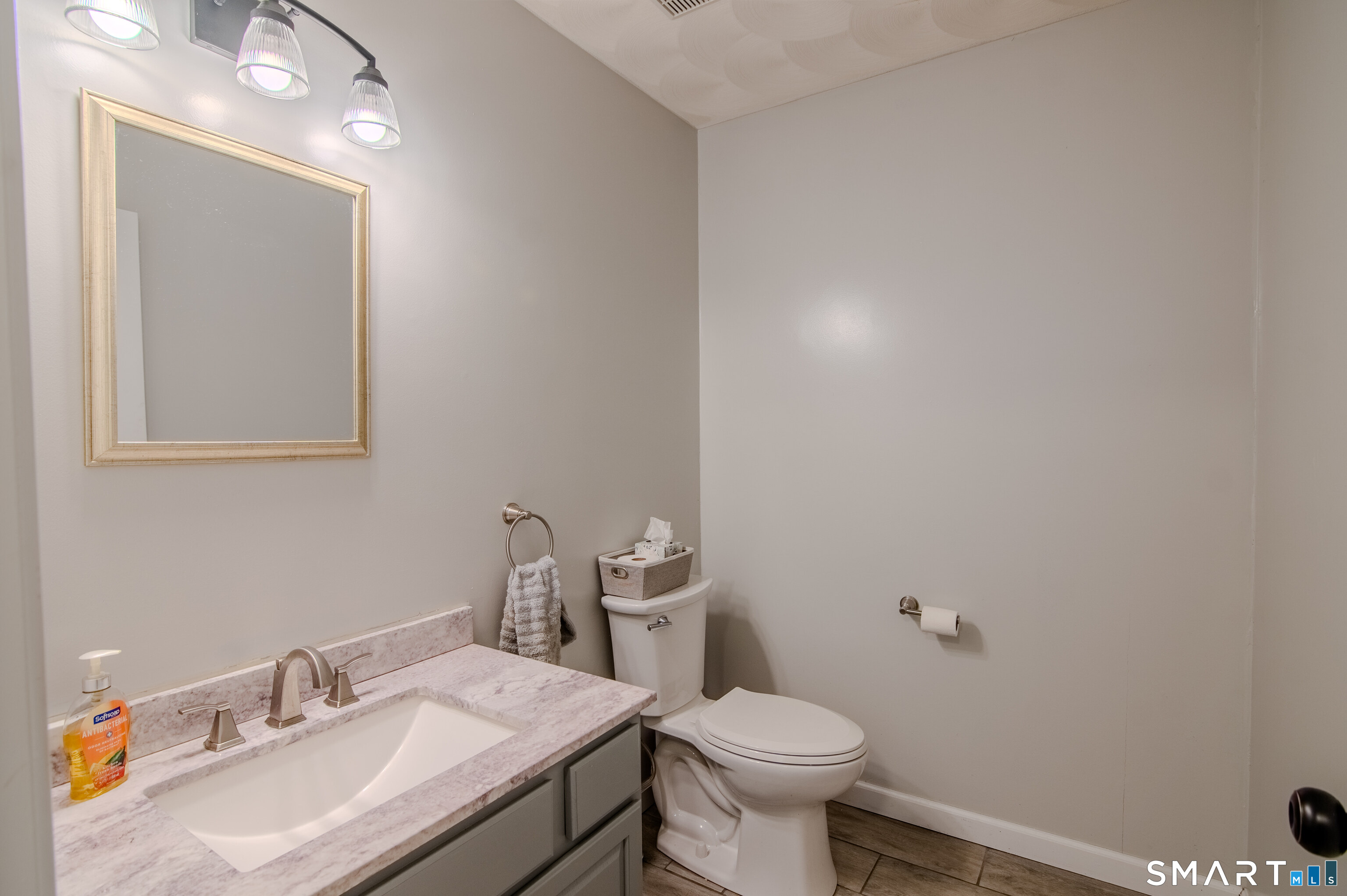 297 Sabin Street, Unit 1 Putnam, CT 06260 - Photo 10 of 20 a bathroom with a sink toilet and vanity