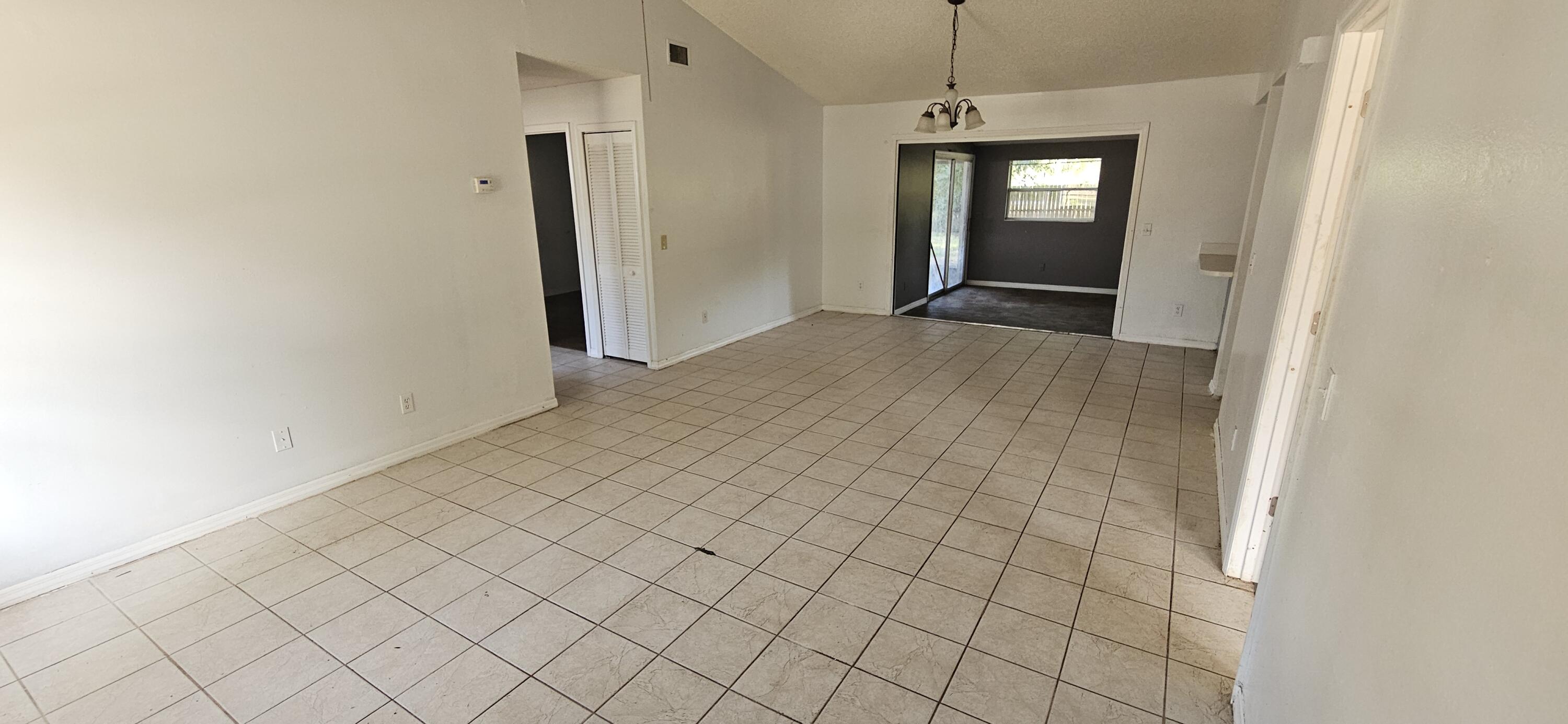340 San Marino Road Southwest Palm Bay, FL 32908 - Photo 2 of 16 an empty room with windows and closet