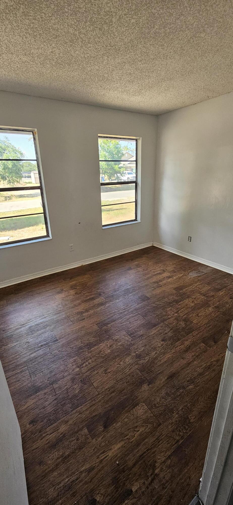 340 San Marino Road Southwest Palm Bay, FL 32908 - Photo 5 of 16 an empty room with wooden floor and windows