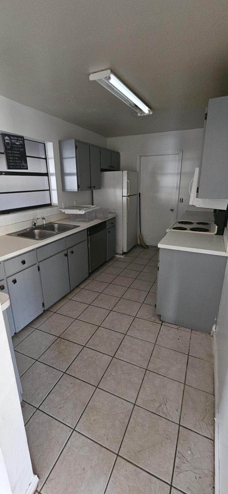 340 San Marino Road Southwest Palm Bay, FL 32908 - Photo 9 of 16 a kitchen with stainless steel appliances granite countertop a sink and cabinets