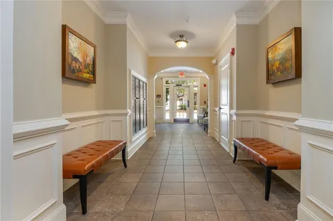 a lobby with furniture and a rug