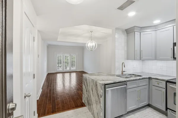 a kitchen with a sink stove and cabinets