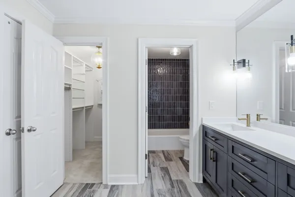 a bathroom with a double vanity sink a mirror and a shower