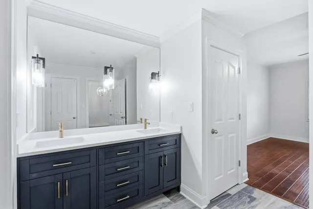 a bathroom with a double vanity sink and a mirror