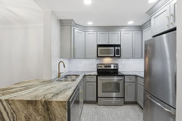 a kitchen with a sink stove and refrigerator