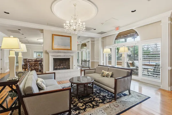 a living room with furniture a chandelier and a chandelier