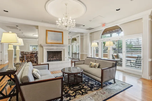a living room with furniture a chandelier and a chandelier