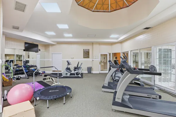a room with gym equipment and windows