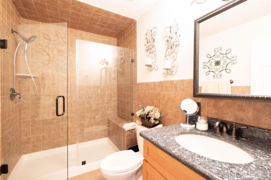 40 Kimberly Road Colonia, NJ 07067 - Photo 15 of 30 a bathroom with a granite countertop sink a toilet and shower