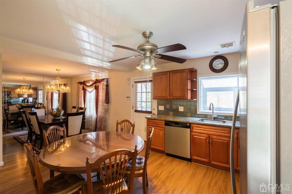 40 Kimberly Road Colonia, NJ 07067 - Photo 2 of 30 a kitchen with granite countertop a dining table chairs and white cabinets