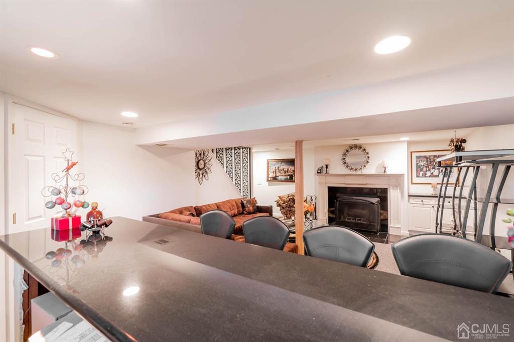 40 Kimberly Road Colonia, NJ 07067 - Photo 22 of 30 a living room with furniture a fireplace and a large window