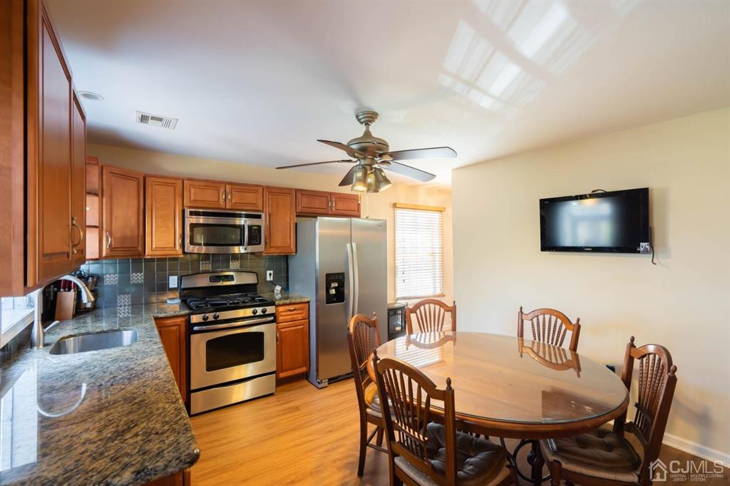 40 Kimberly Road Colonia, NJ 07067 - Photo 26 of 30 a view of a a dining room with furniture window and wooden floor